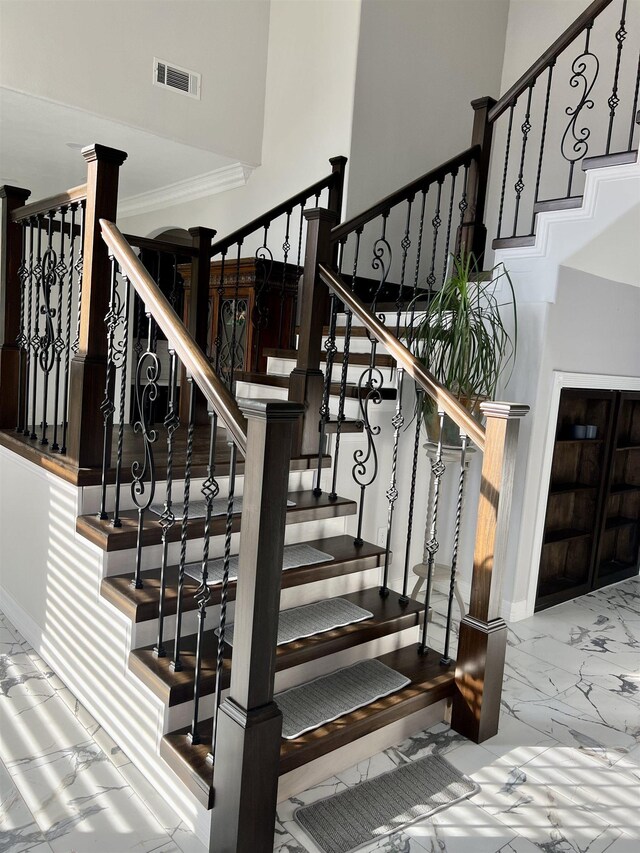 stairway featuring crown molding