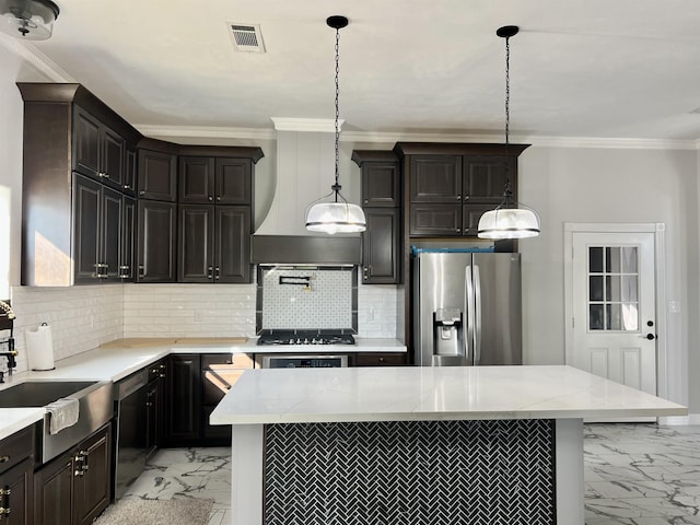 kitchen with stainless steel fridge with ice dispenser, backsplash, decorative light fixtures, and a center island