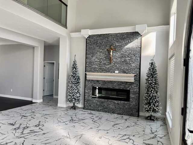 living room featuring a fireplace and a towering ceiling