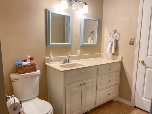 bathroom featuring toilet, vanity, and tile patterned floors