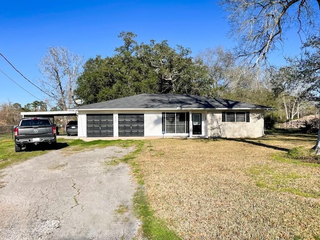 single story home with a front yard and a carport