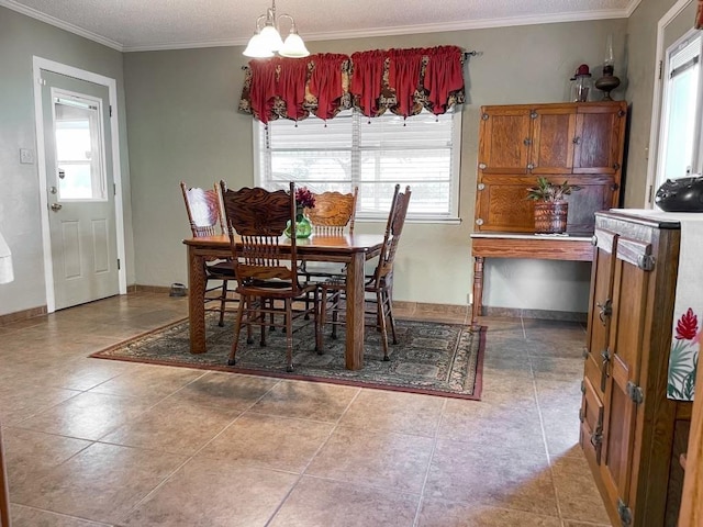 dining room with tile patterned flooring, a notable chandelier, and ornamental molding