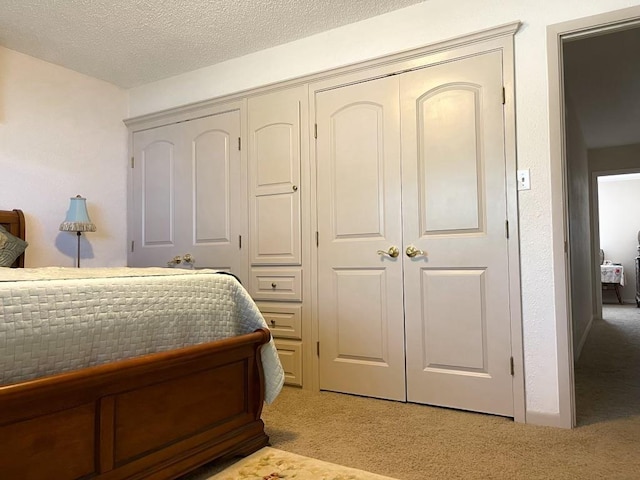 carpeted bedroom with a textured ceiling