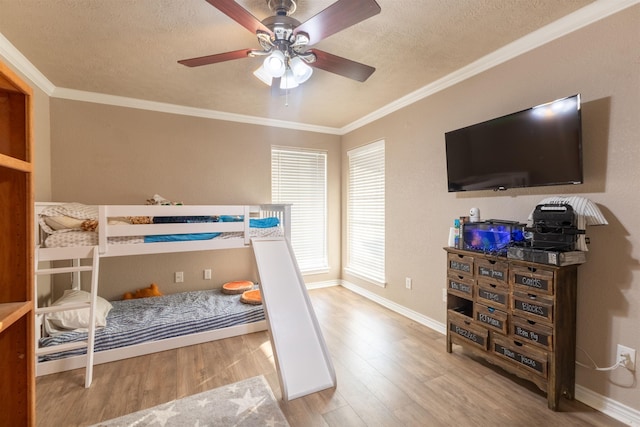 bedroom featuring ceiling fan, crown molding, a textured ceiling, and light wood-type flooring