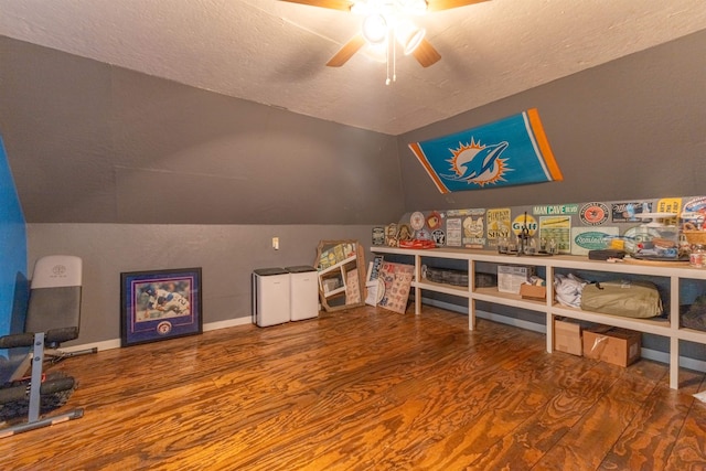 playroom featuring hardwood / wood-style floors, ceiling fan, lofted ceiling, and a textured ceiling