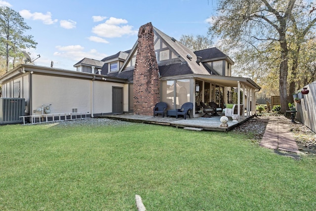 rear view of property with a wooden deck, a yard, and central AC unit