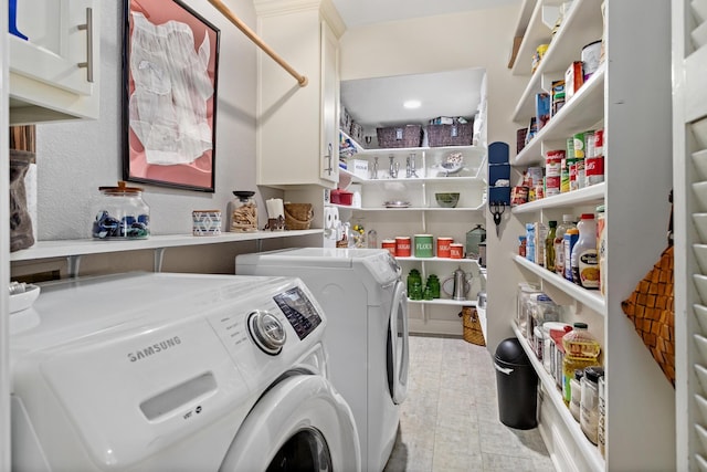 washroom featuring cabinets and separate washer and dryer