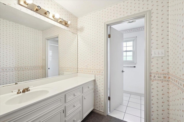 bathroom featuring vanity, tile patterned flooring, and wallpapered walls