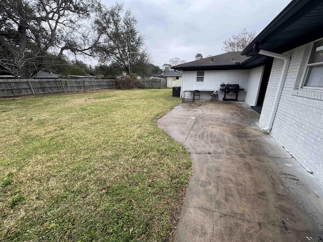 view of yard with central air condition unit and a patio area