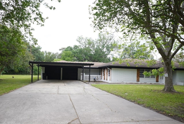 ranch-style home with driveway, an attached carport, and a front yard