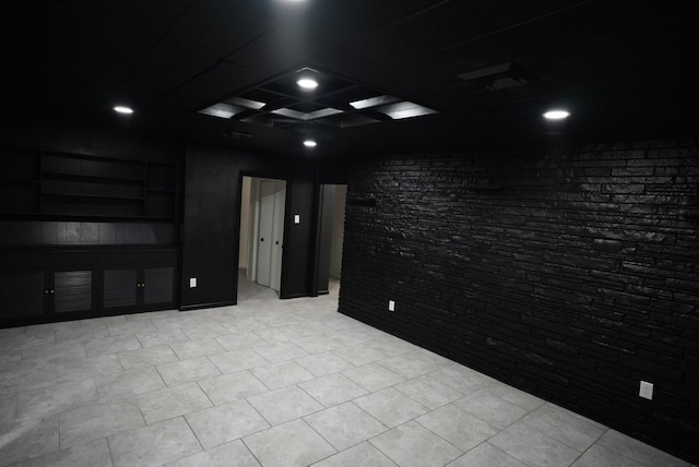 spare room featuring brick wall and recessed lighting