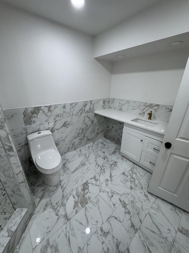 bathroom featuring tile walls, toilet, and vanity