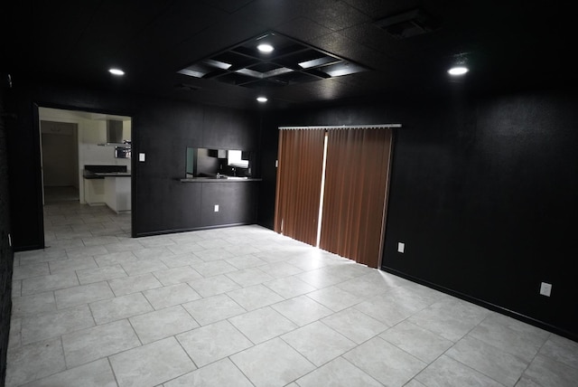 empty room with recessed lighting and coffered ceiling