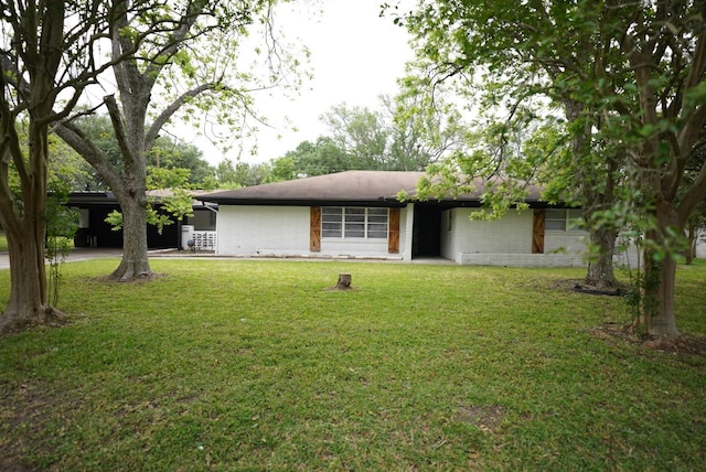 ranch-style house featuring a front yard and an attached carport