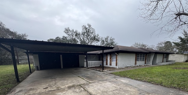 single story home with a front lawn and a carport