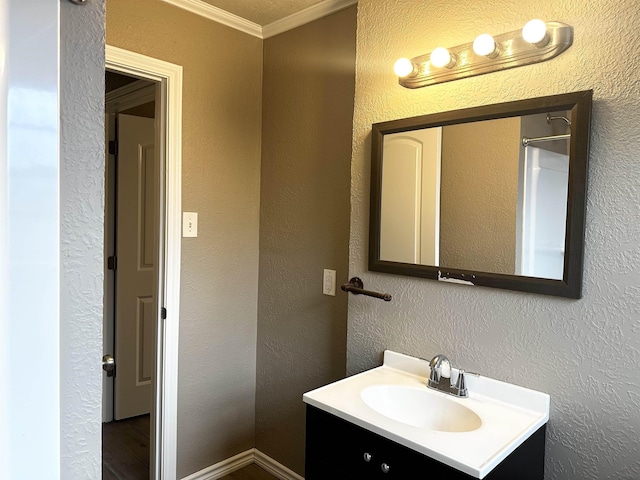 7165 Lewis Dr, Beaumont, TX 77708 - bathroom featuring vanity, ornamental molding, and a textured wall