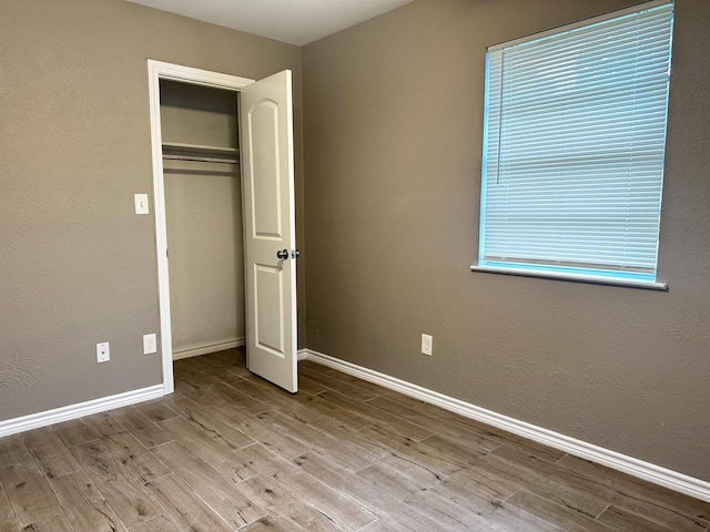 7165 Lewis Dr, Beaumont, TX 77708 - unfurnished bedroom featuring wood finished floors, baseboards, and a closet