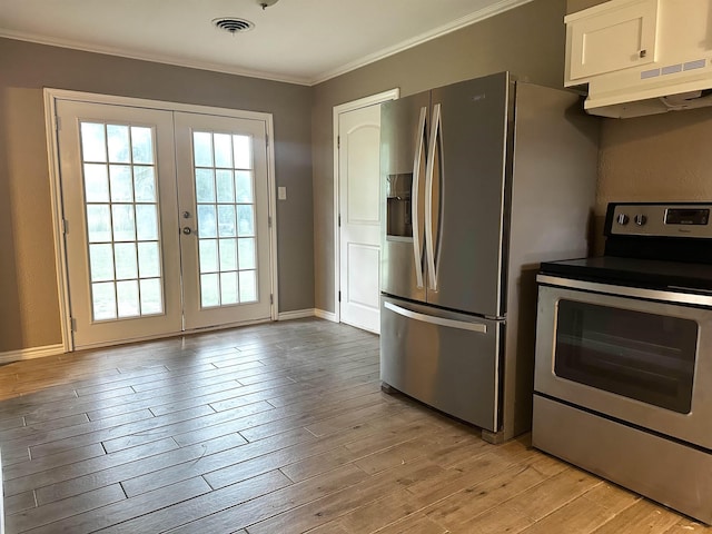 7165 Lewis Dr, Beaumont, TX 77708 - kitchen with stainless steel appliances, under cabinet range hood, ornamental molding, white cabinets, and french doors