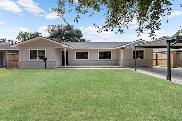 single story home featuring roof with shingles, a front lawn, an attached carport, fence, and brick siding