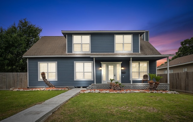 view of front of house featuring a yard and covered porch