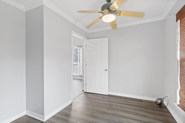 spare room featuring crown molding, ceiling fan, and dark wood-type flooring