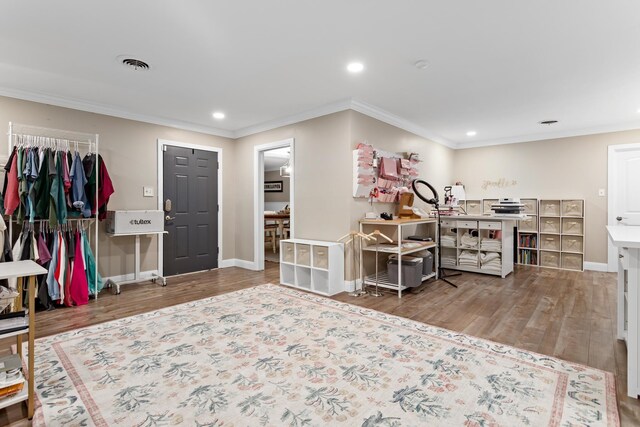 interior space featuring wood-type flooring and crown molding