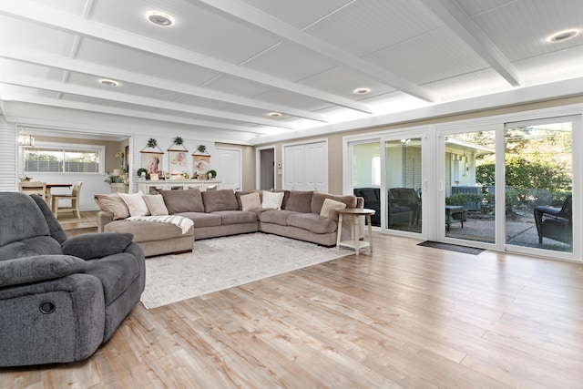 living room with light hardwood / wood-style flooring and beamed ceiling