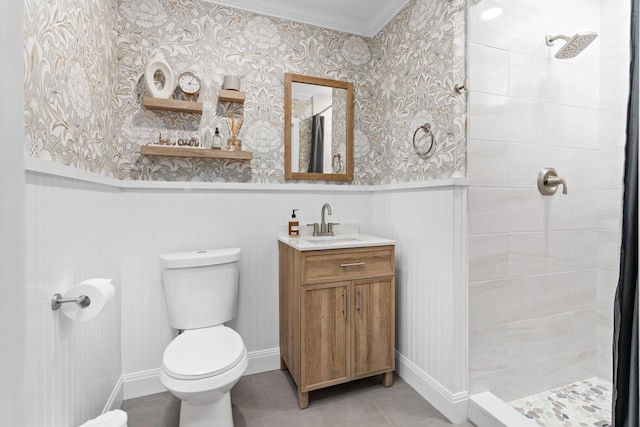 bathroom with vanity, tile patterned floors, toilet, ornamental molding, and walk in shower