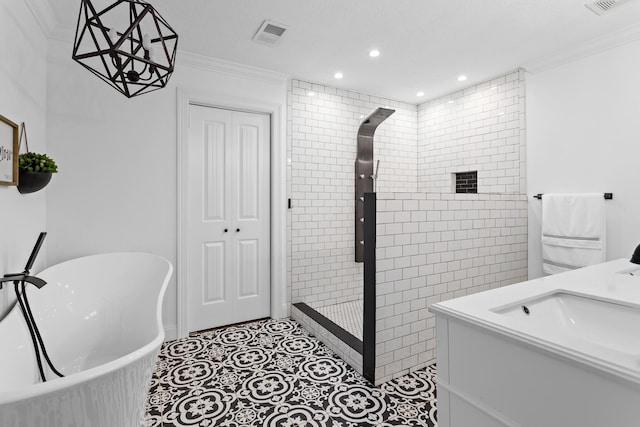 bathroom featuring plus walk in shower, vanity, ornamental molding, and tile patterned flooring