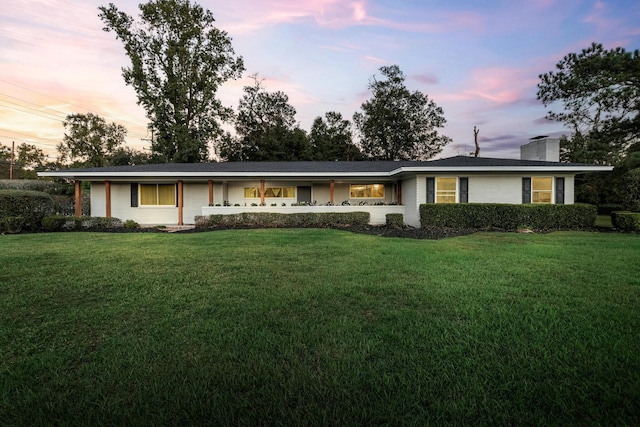 ranch-style home featuring a lawn