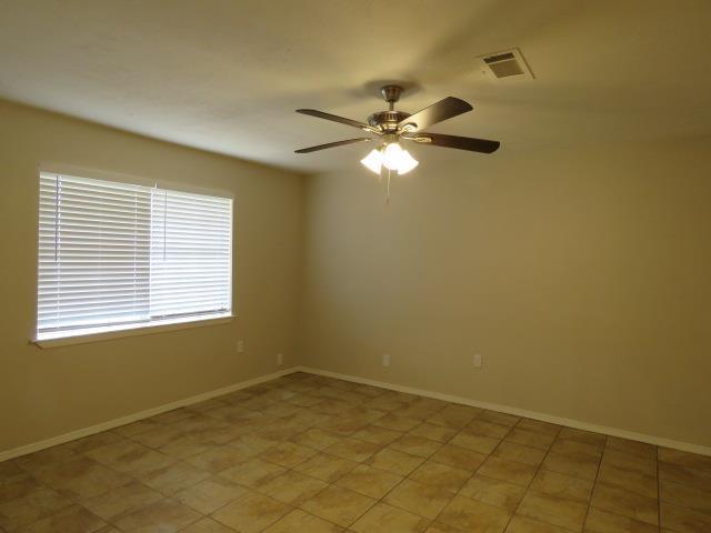800 Cactus St, Bridge City, TX 77611 - spare room featuring a ceiling fan and baseboards