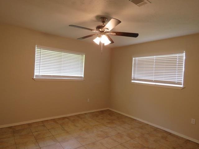 800 Cactus St, Bridge City, TX 77611 - spare room featuring ceiling fan and baseboards