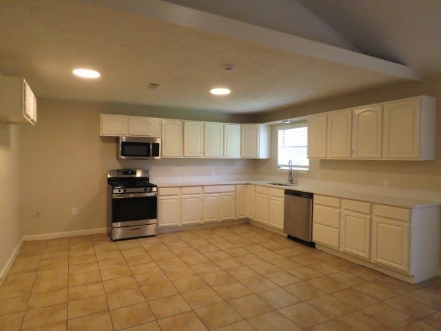 800 Cactus St, Bridge City, TX 77611 - kitchen featuring stainless steel appliances, light countertops, white cabinets, recessed lighting, and light tile patterned floors