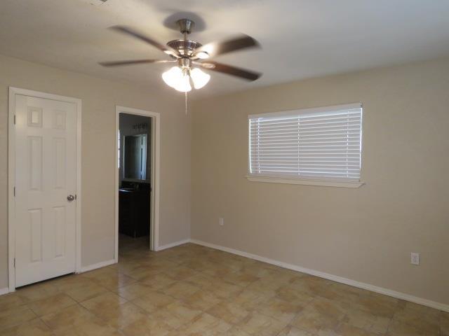 800 Cactus St, Bridge City, TX 77611 - unfurnished room featuring a ceiling fan and baseboards