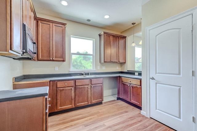 770 Elgie St, Beaumont, TX 77705 - kitchen with stainless steel microwave, plenty of natural light, light wood-type flooring, hanging light fixtures, and recessed lighting