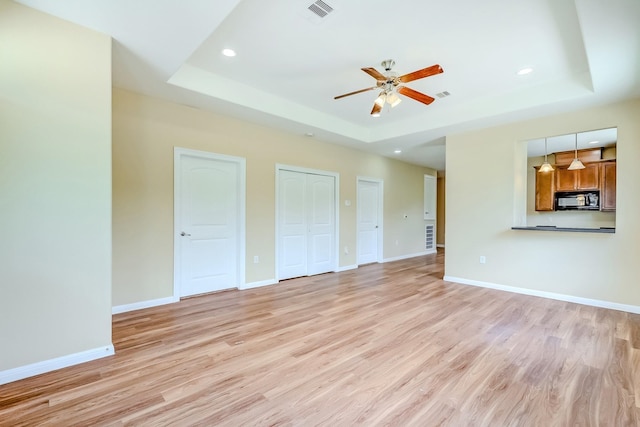 770 Elgie St, Beaumont, TX 77705 - unfurnished living room with a tray ceiling, light wood-style floors, ceiling fan, and recessed lighting