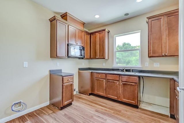 770 Elgie St, Beaumont, TX 77705 - kitchen featuring black microwave, light wood-type flooring, brown cabinetry, and recessed lighting