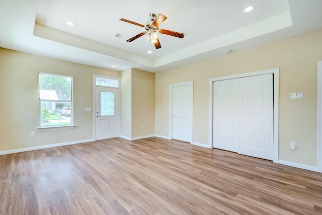 770 Elgie St, Beaumont, TX 77705 - unfurnished bedroom featuring a tray ceiling, light wood finished floors, recessed lighting, and a ceiling fan