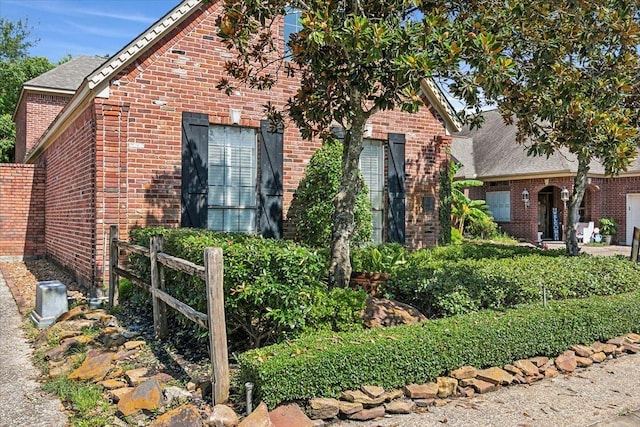 english style home featuring brick siding