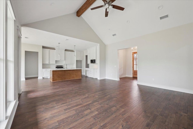 unfurnished living room with dark wood-style flooring, baseboards, beam ceiling, visible vents, and a ceiling fan