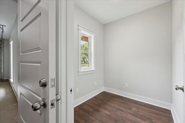 interior space with baseboards and wood finished floors