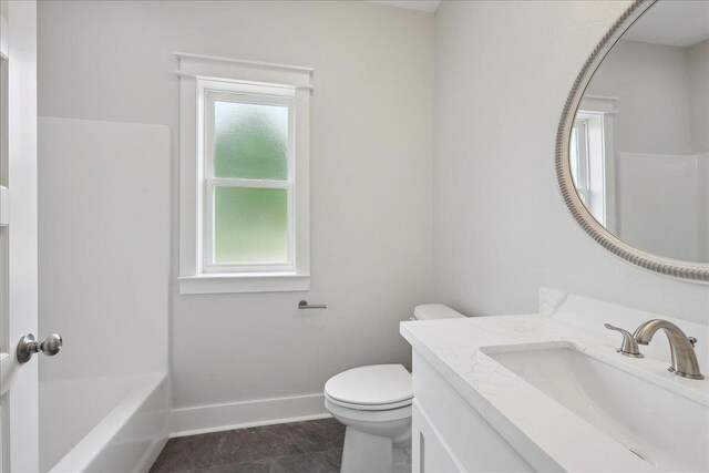 full bath featuring toilet, a shower, vanity, a tub, and baseboards