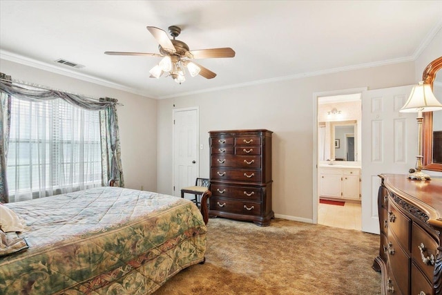 carpeted bedroom featuring ceiling fan, ornamental molding, and ensuite bathroom