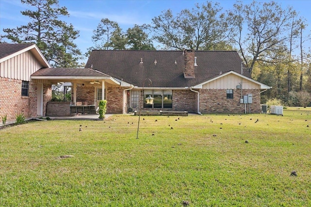 back of property featuring ceiling fan, a yard, a patio, and central AC