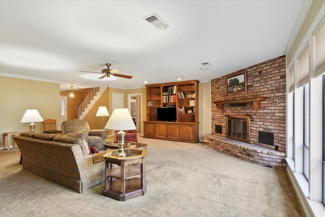 living room featuring light carpet, ceiling fan, crown molding, a fireplace, and radiator heating unit