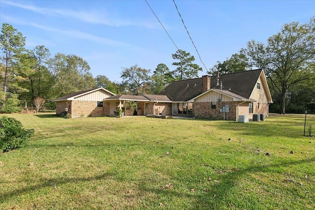 exterior space with a front yard and central air condition unit