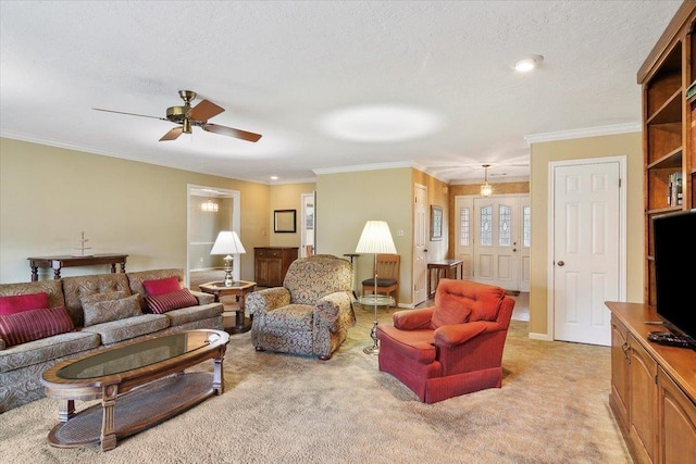 living room with a textured ceiling, light colored carpet, ceiling fan, and crown molding