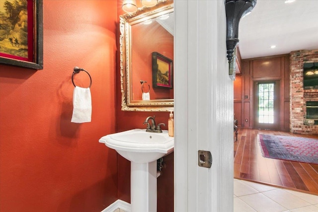 bathroom with tile patterned floors and a fireplace