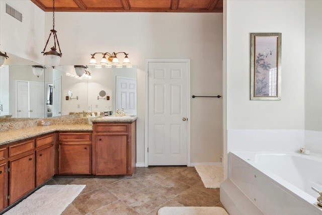 bathroom with tile patterned flooring, vanity, and a bathtub