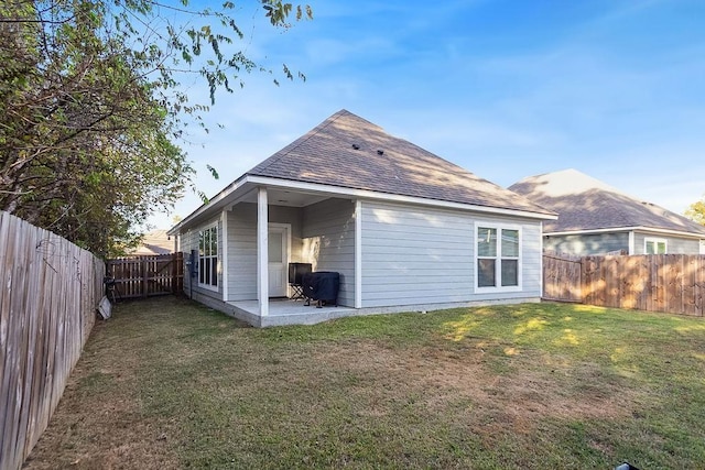 rear view of house with a lawn